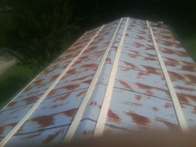 Rusted metal roof panels with new wood purlins before replacement — Storm Damage Roof Repair in Nazareth by Roofing Brothers
