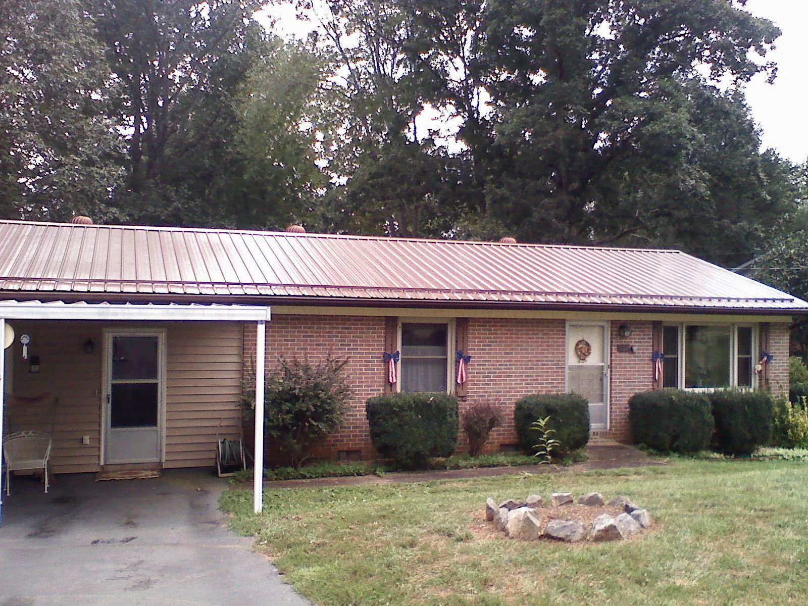 Bronze metal roof and carport on a brick ranch home — Roof Repair work by our crew in Nazareth