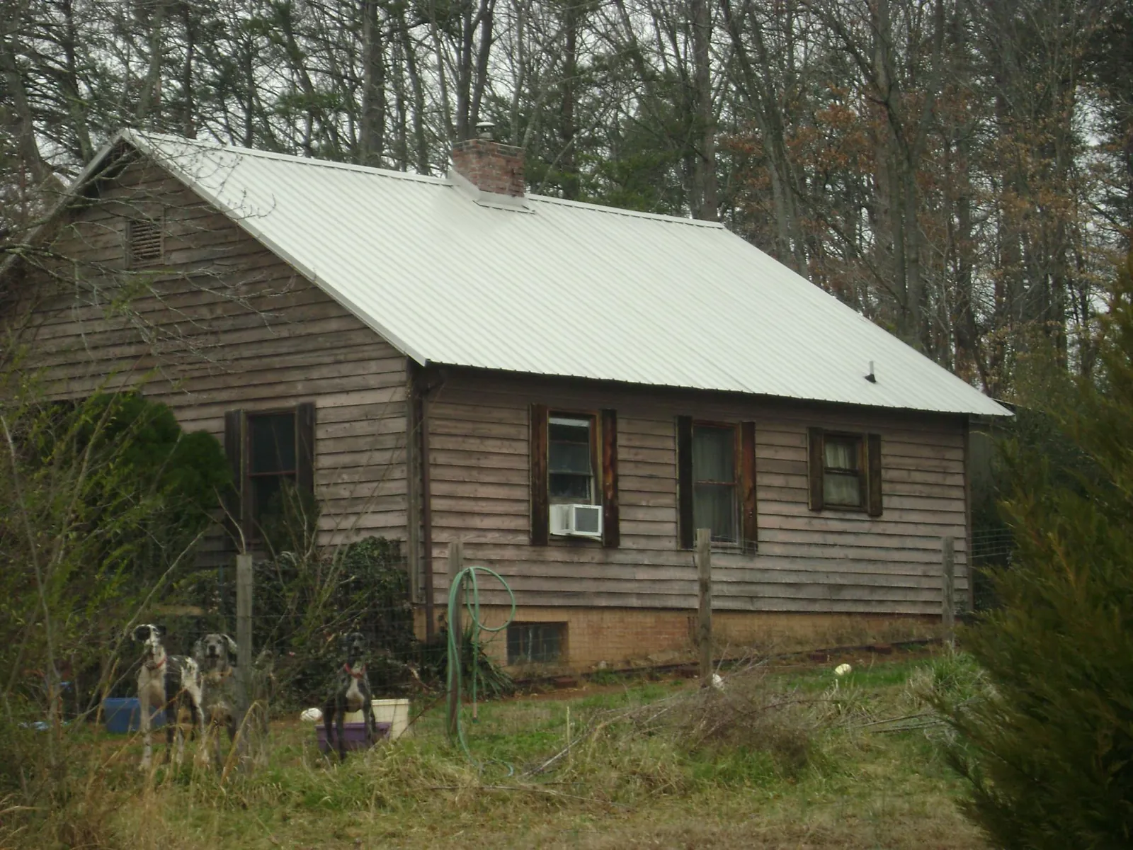 White metal roof on an old wood sided farmhouse, from a Metal Roof Installation job in Nazareth